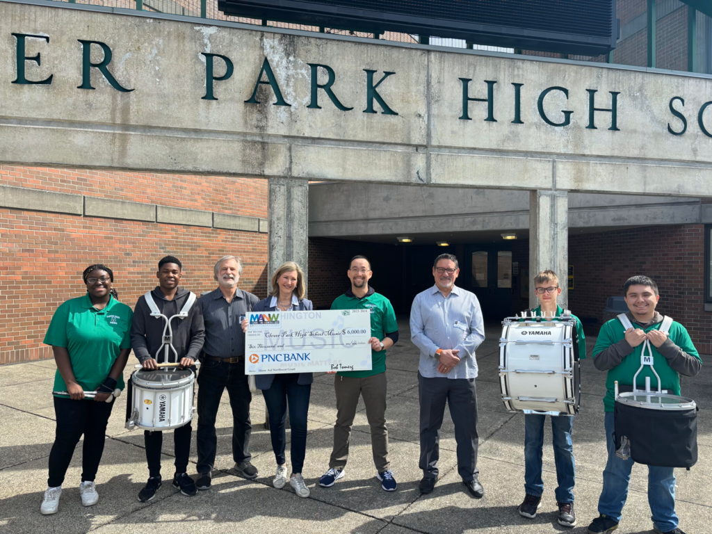 Pamela Baade, Director of Client and Community Relations for PNC Bank, our Presenting Sponsor for Play It Forward 2024, presented a check to Clover Park High School Music Director, Geoffrey Smith