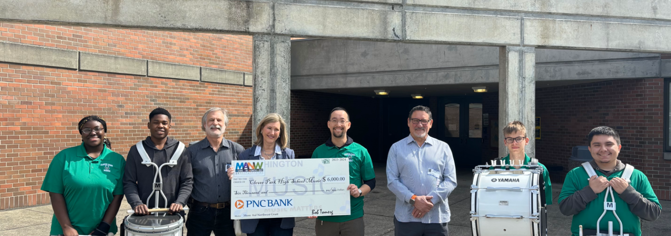 Pamela Baade, Director of Client and Community Relations for PNC Bank, our Presenting Sponsor for Play It Forward 2024, presented Clover Park High School Music Director, Geoffrey Smith