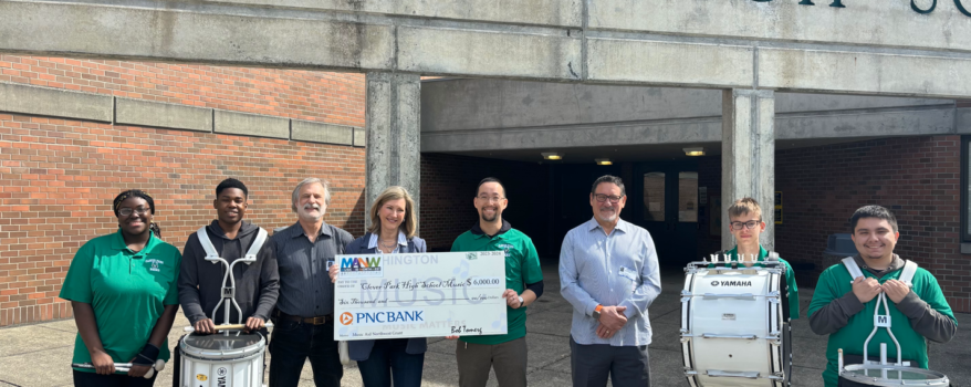 Pamela Baade, Director of Client and Community Relations for PNC Bank, our Presenting Sponsor for Play It Forward 2024, presented Clover Park High School Music Director, Geoffrey Smith