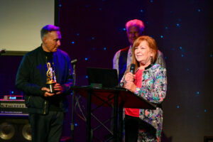 Executive Director Dow Constantine presents to King County Creative Economy Director, Kate Becker, the 2024 Music Icon Award